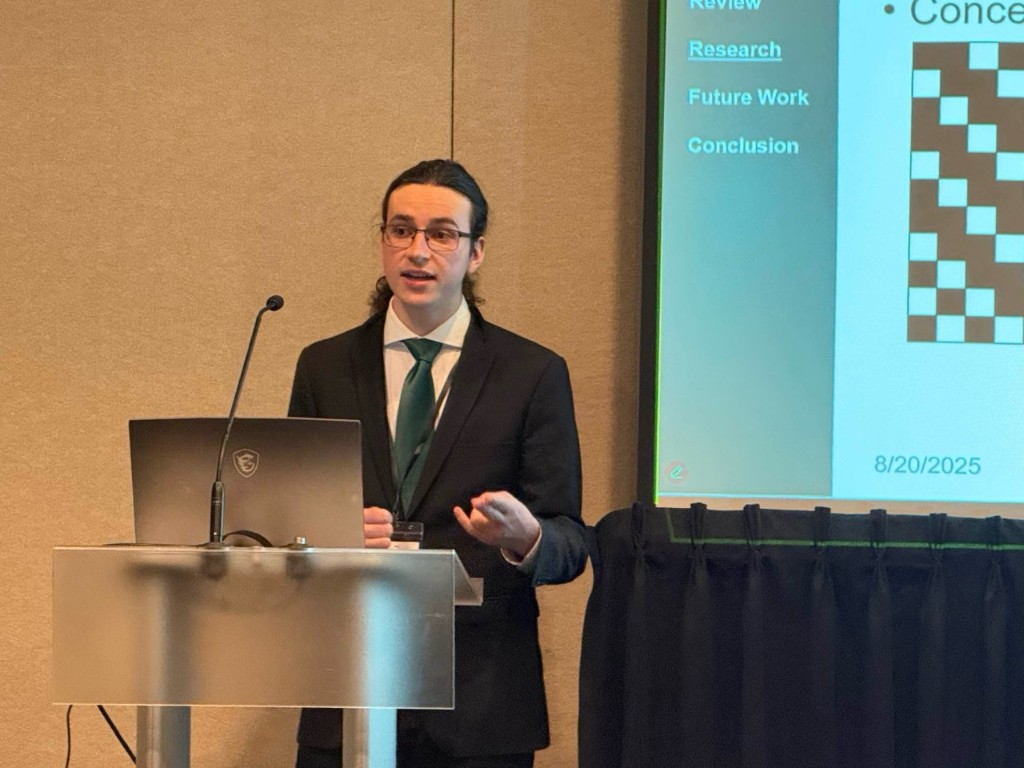 Jared Hirt at the podium during the IEEE UIC talk